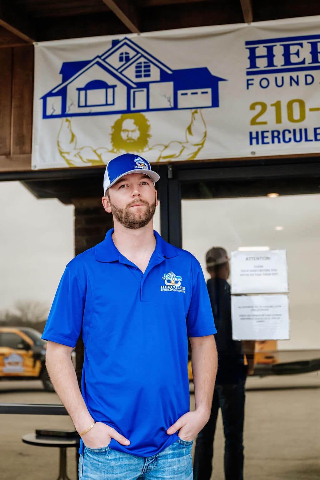 Collin A. of Hercules Foundation Repair in front of the company sign